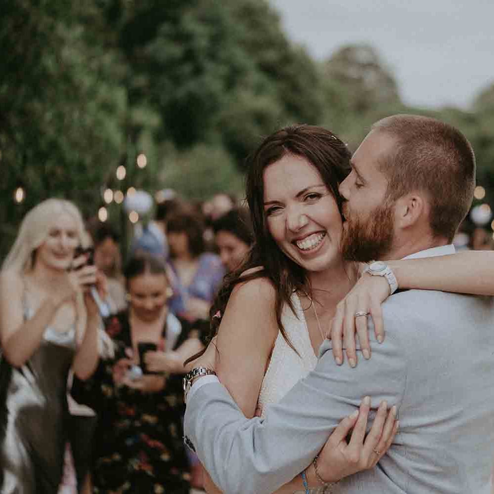 Groom kisses his new wife on the cheek