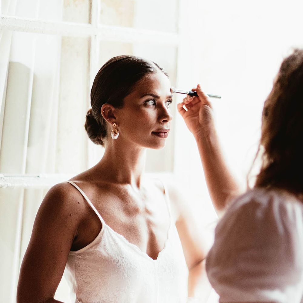 Bride has her makeup done on the morning of her wedding day