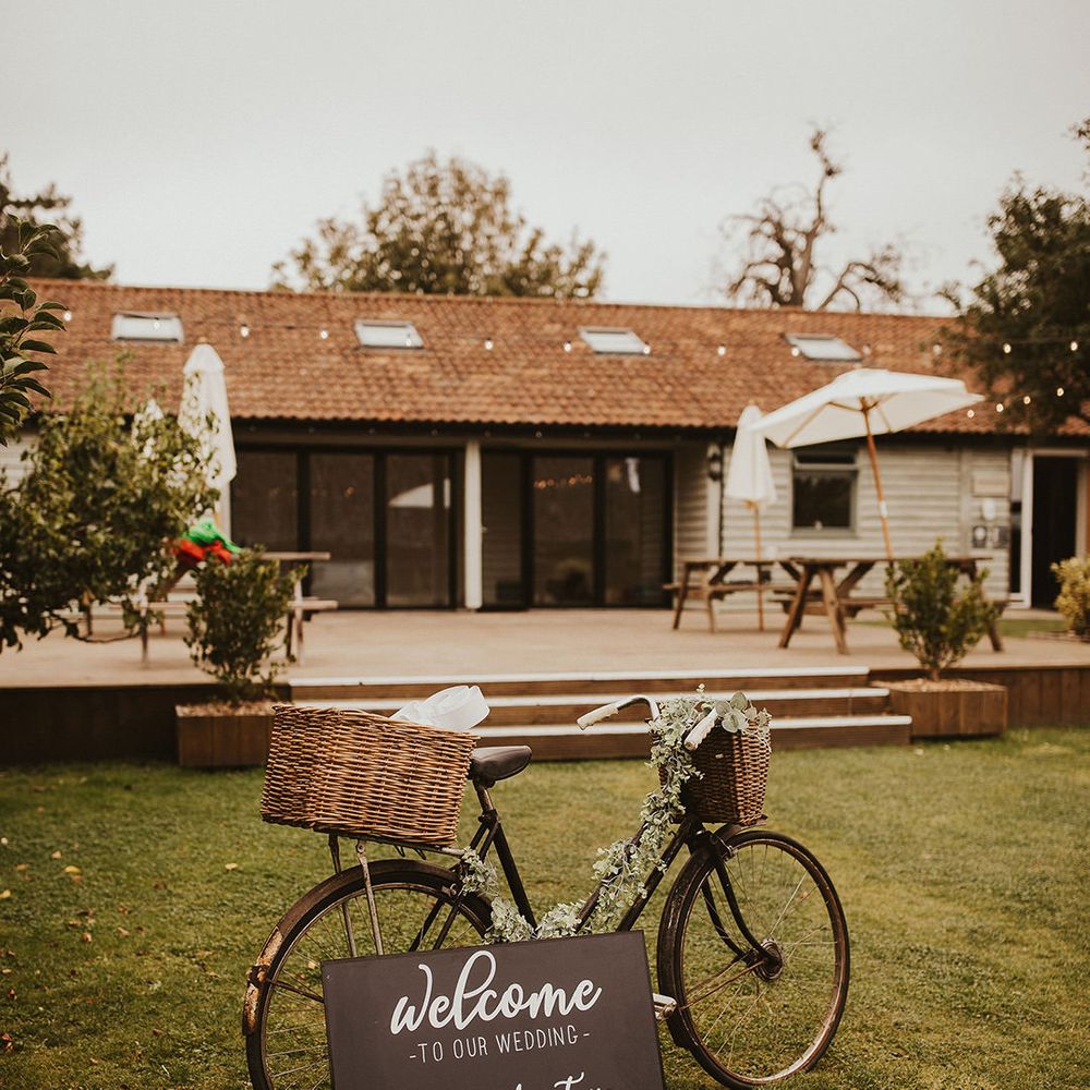 Rustic bike decor with chalkboard wedding sign at East Afton Farmhouse