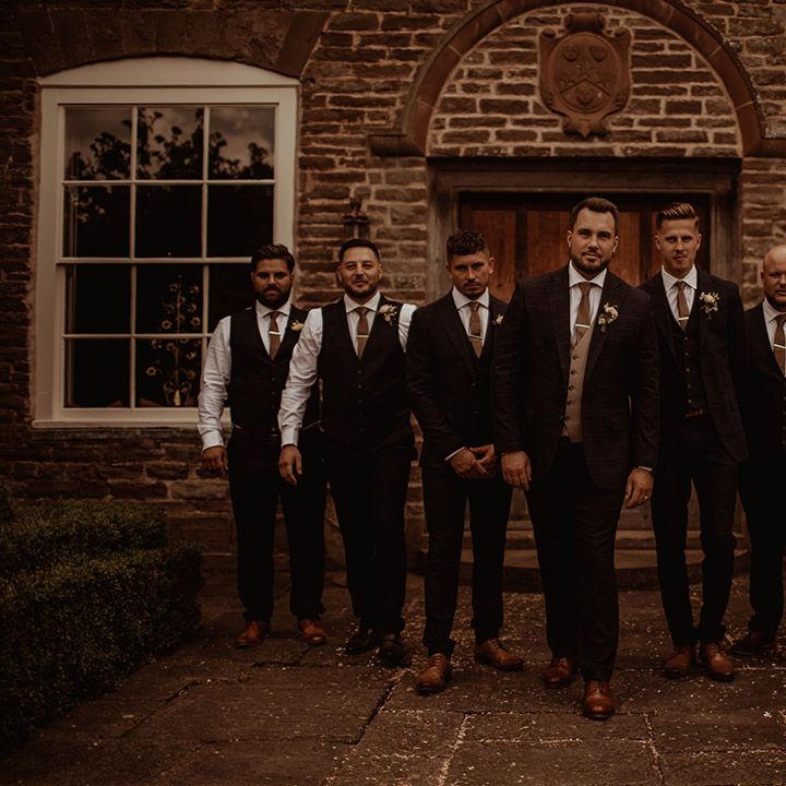 Groom and groomsmen in check suits at Dewsall Court wedding 