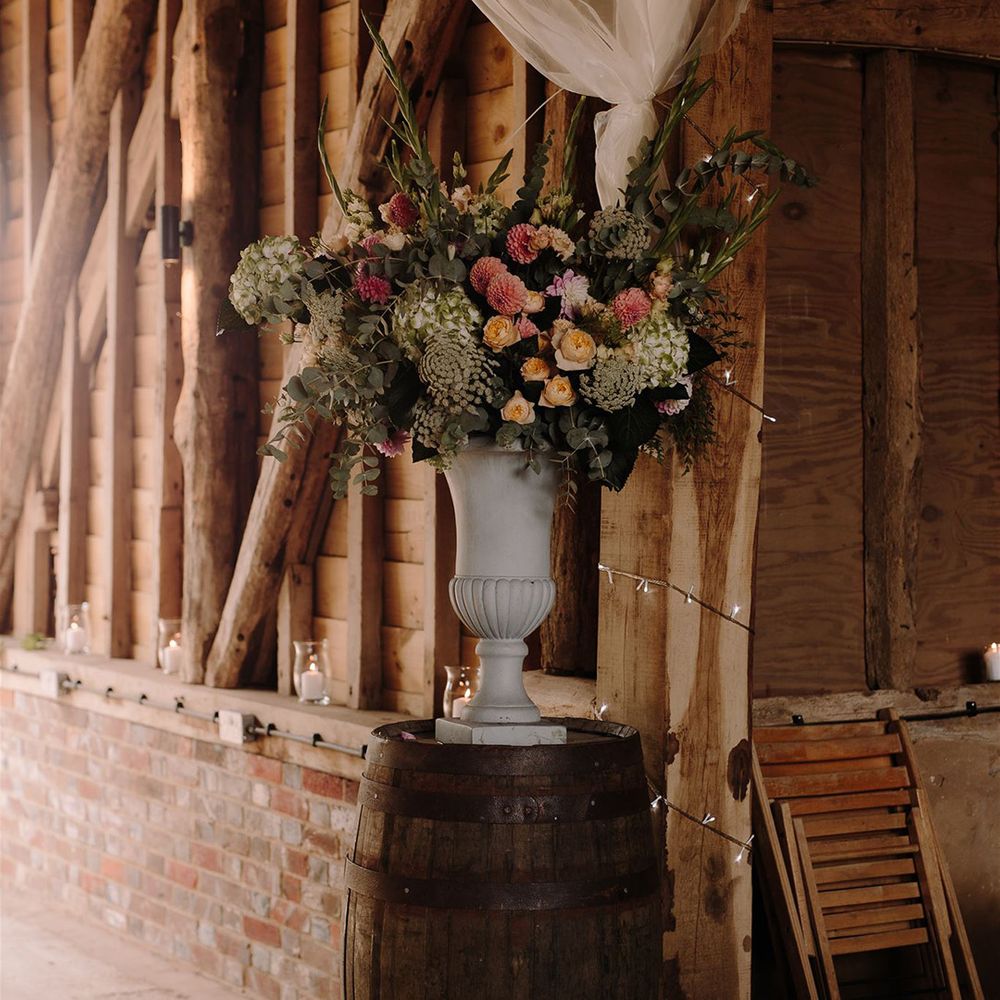 Blush and cream wedding flowers in decorative vase for wedding