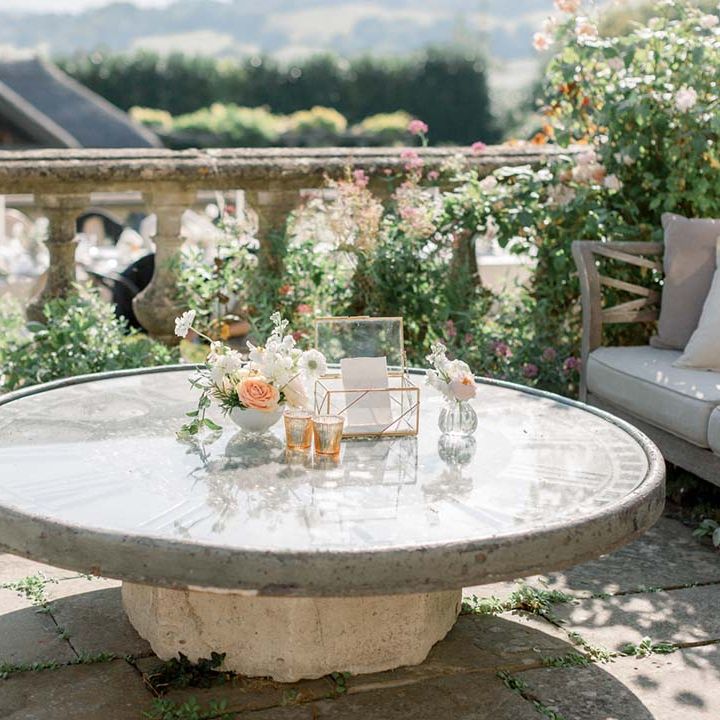 Outdoor wedding setting complete with green foliage and pastel florals 