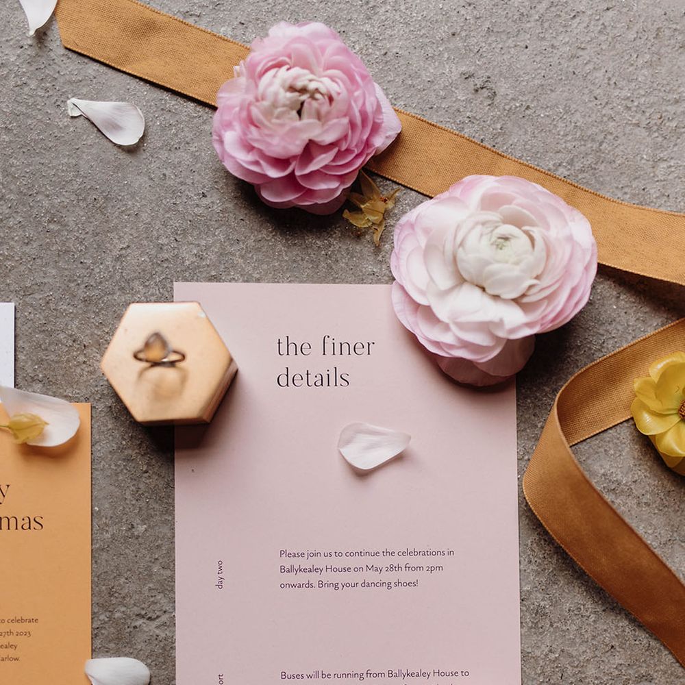 Contemporary pastel pink wedding stationery design with black font 