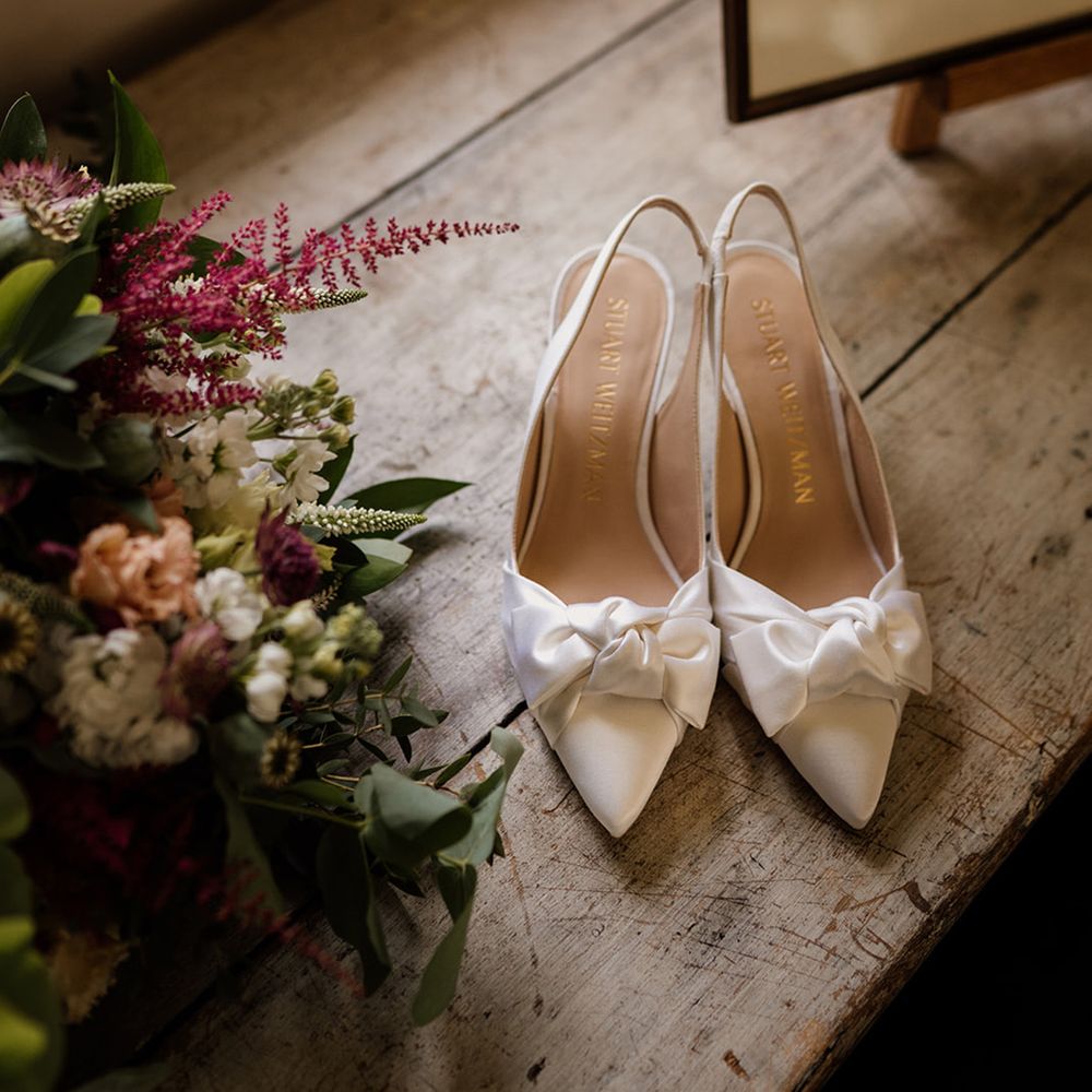 White pointed slingback wedding shoes with bow from Stuart Weitzman 