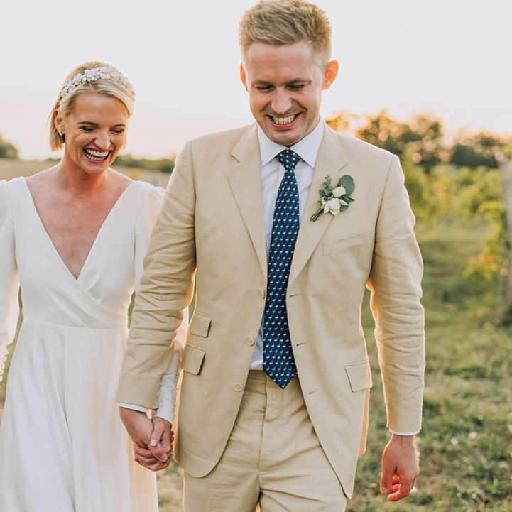 golden hour wedding photograph at Château de Malliac with groom in a stone suit and bride in a bespoke wedding dress