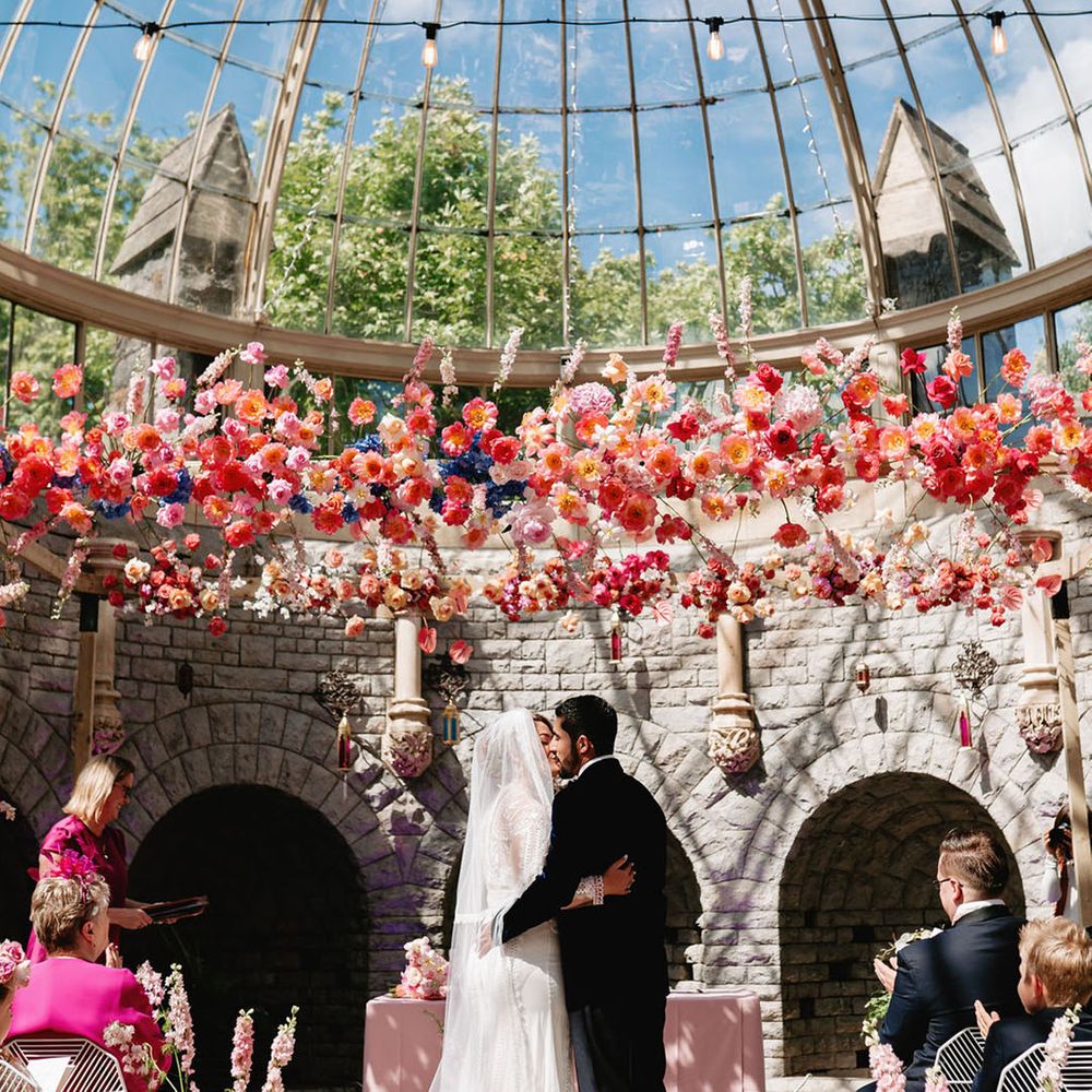 Glasshouse wedding venue in the Cotswolds with the bride na groom sharing their first kiss as a married couple 