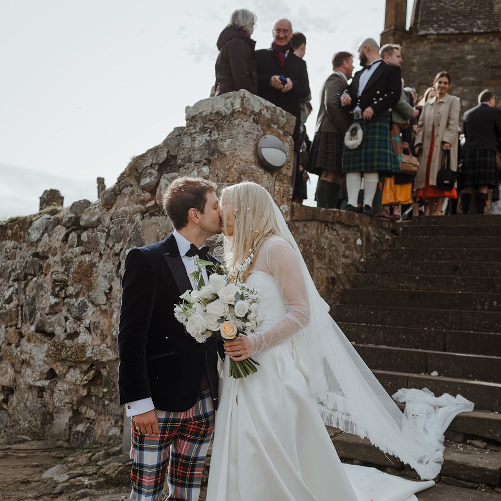 The bride and groom share an intimate kiss together after their confetti exit 