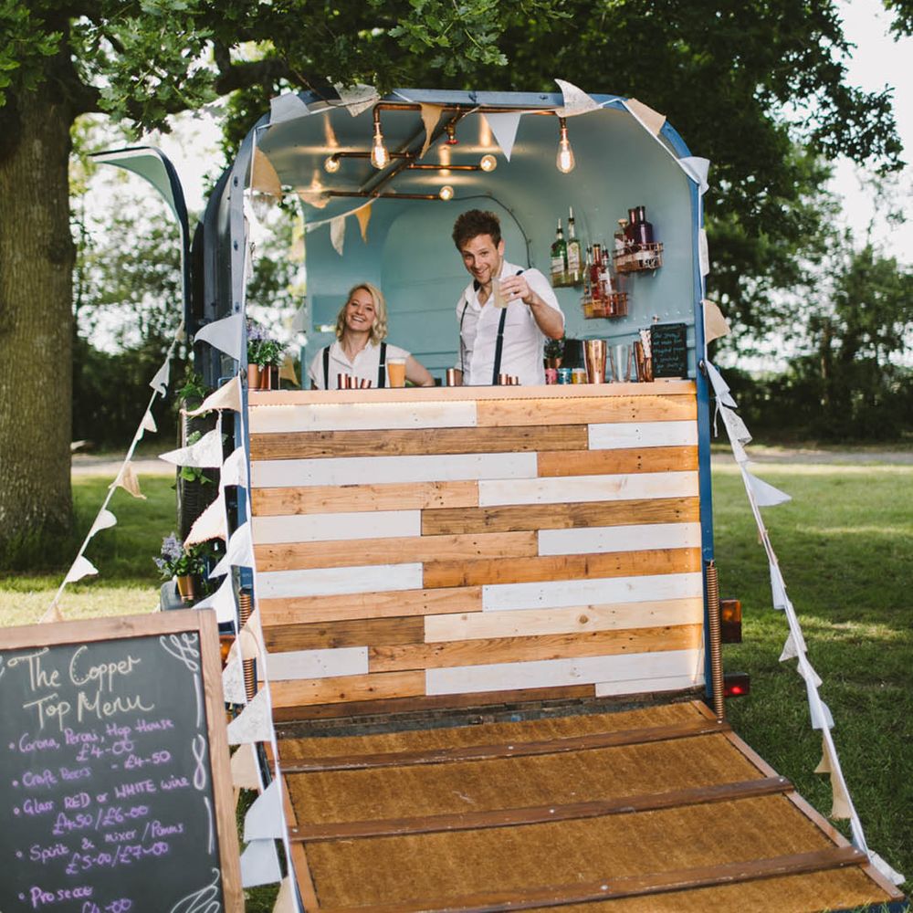 Outdoor wedding bar with bunting and festoon lighting decorations 