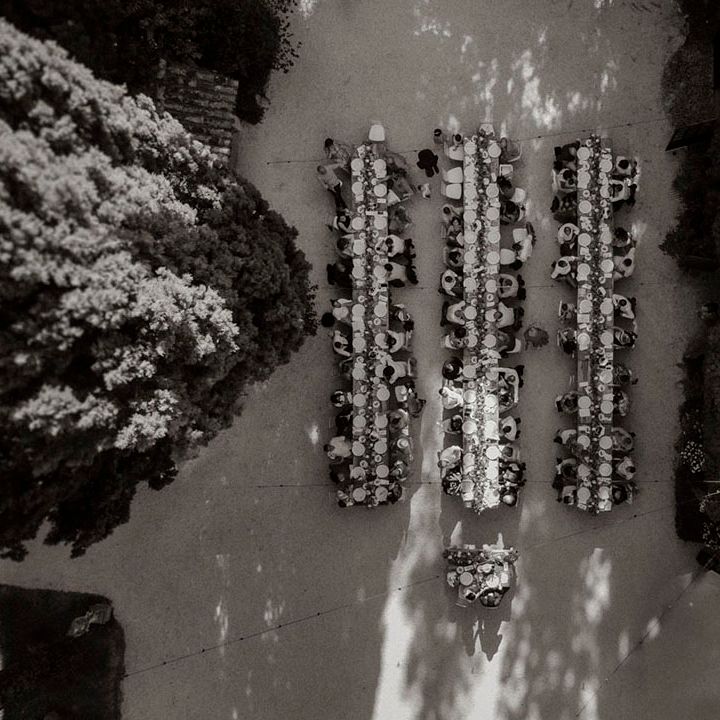 Long tables at outdoor wedding breakfast Italian destination wedding 