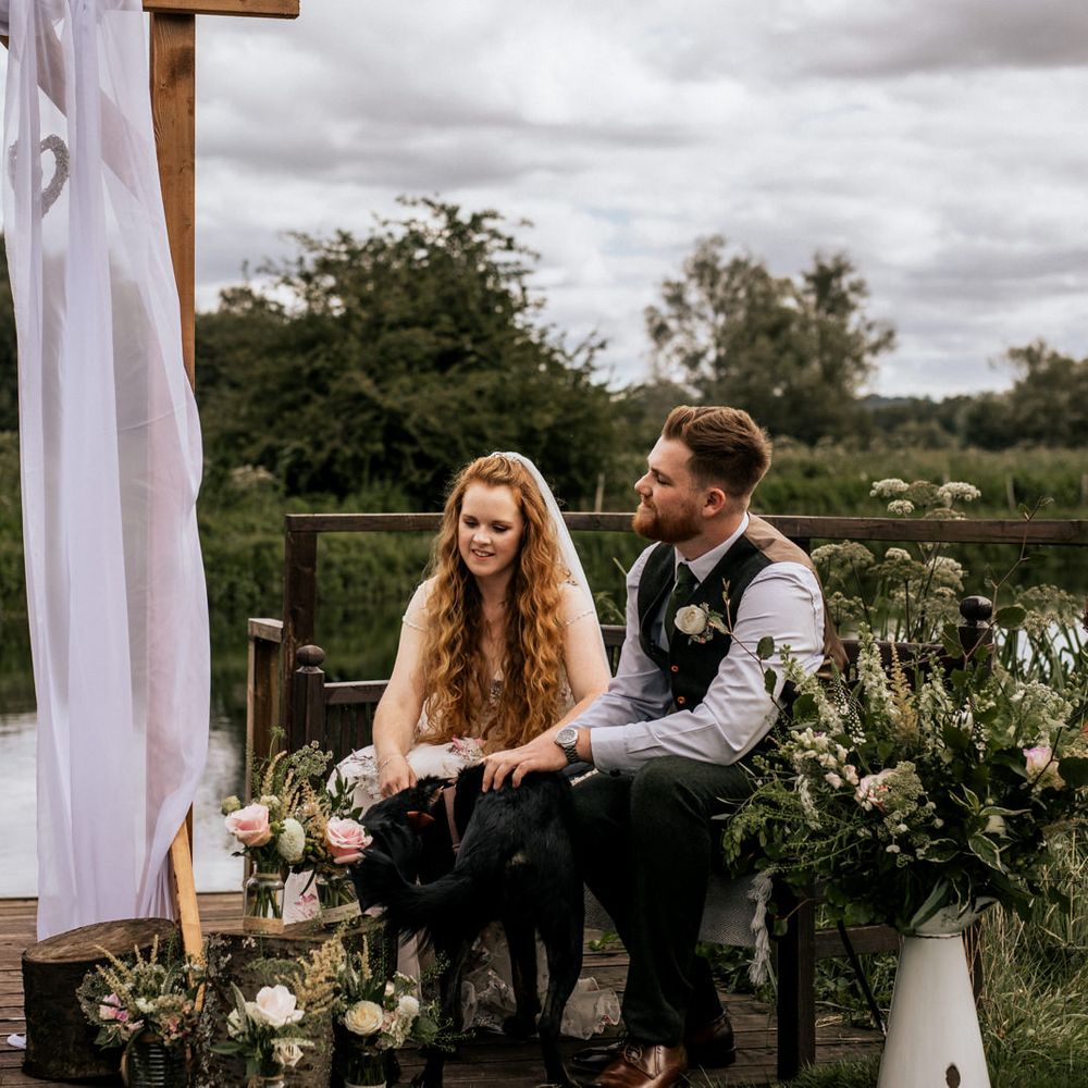 Bride & groom during wedding ceremony in front of river
