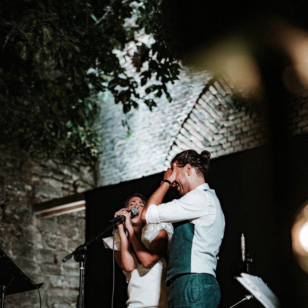 Bride and groom singing at Italian destination wedding reception 