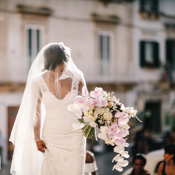 Bride wearing long sleeved sheer bridal gown for Italian wedding