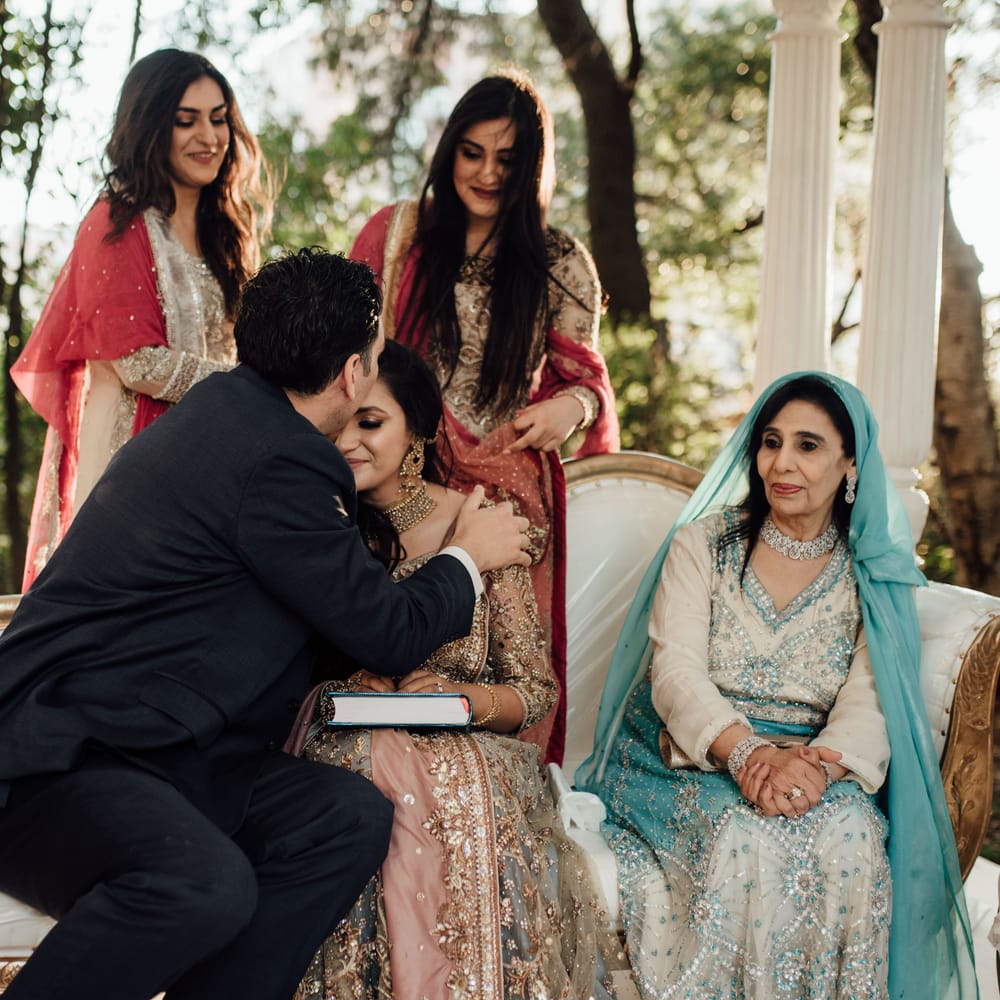 Groom kisses bride on her forehead during wedding ceremony