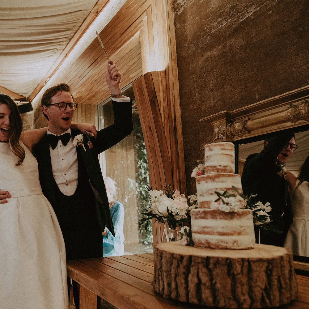 Bride & groom celebrate after they cut their cake