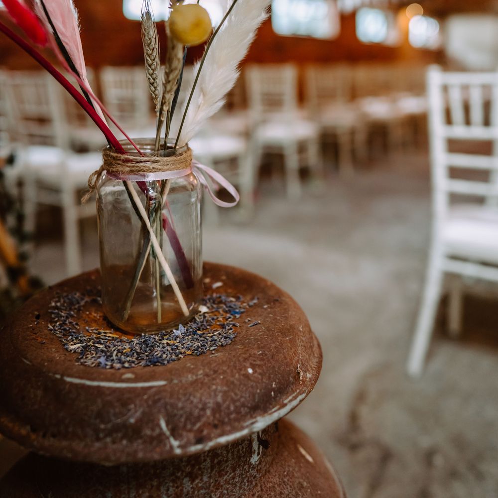 Dried florals and pampas grass in mason jar tied with brown string