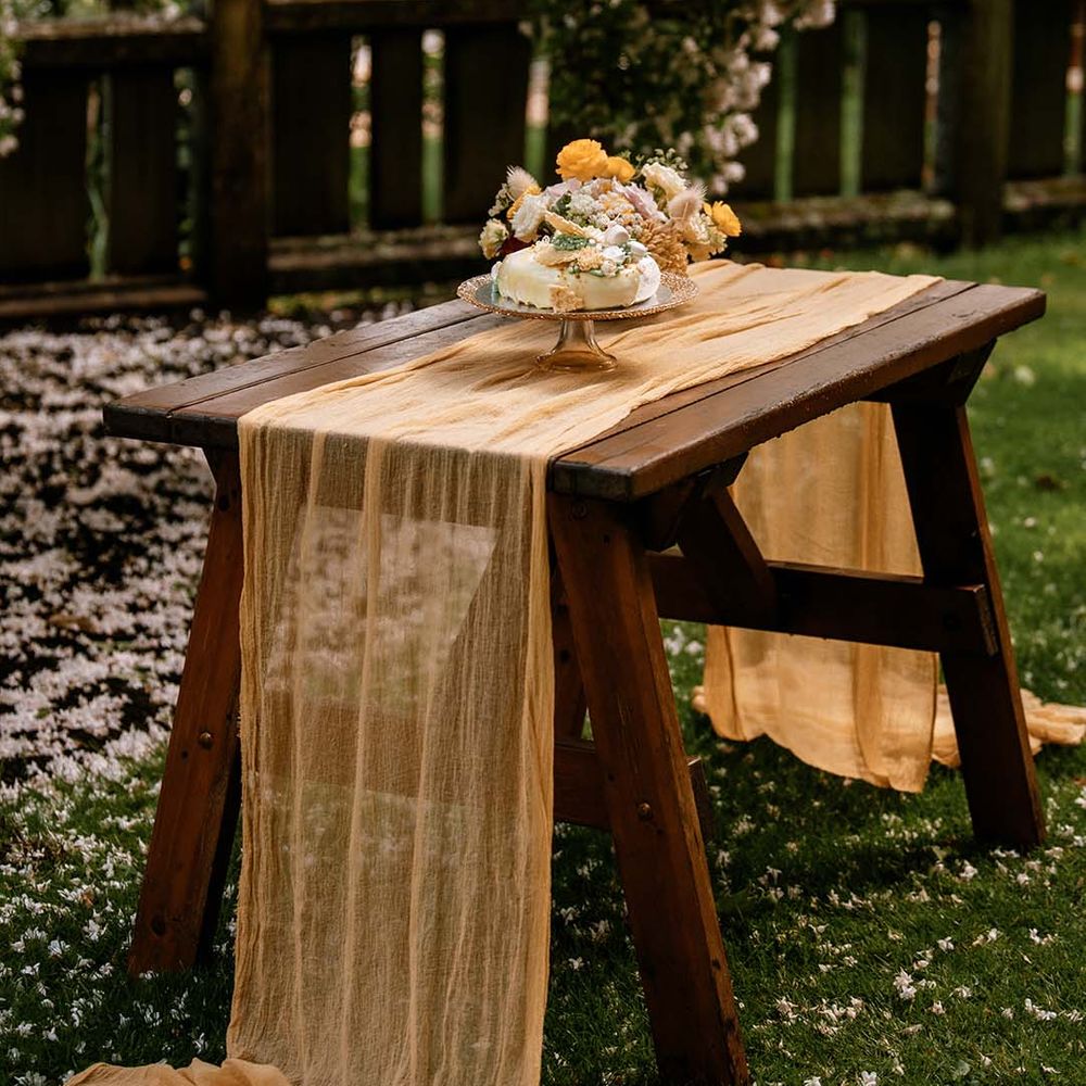 cake table with linen table runner and single tier wedding cake 
