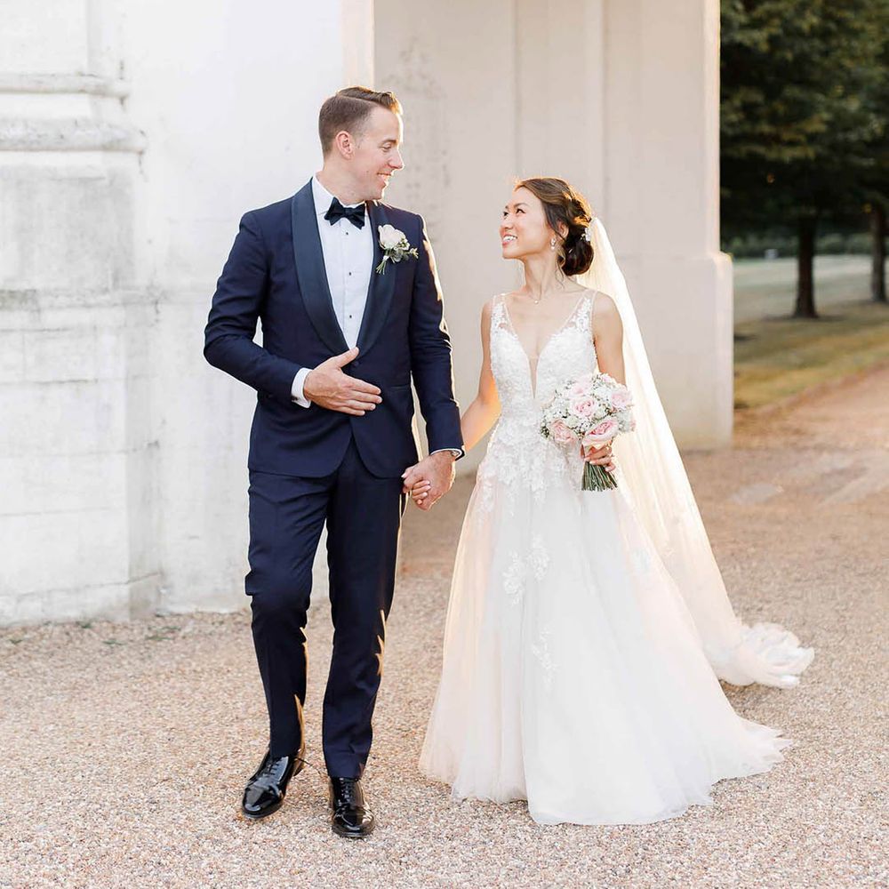 Bride & groom walk together through the grounds of Danesfield House after ceremony