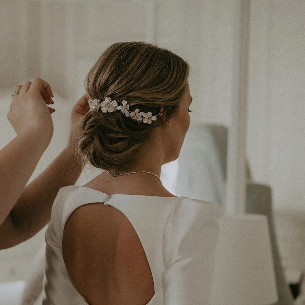 White open back wedding dress and flower style long hair clip
