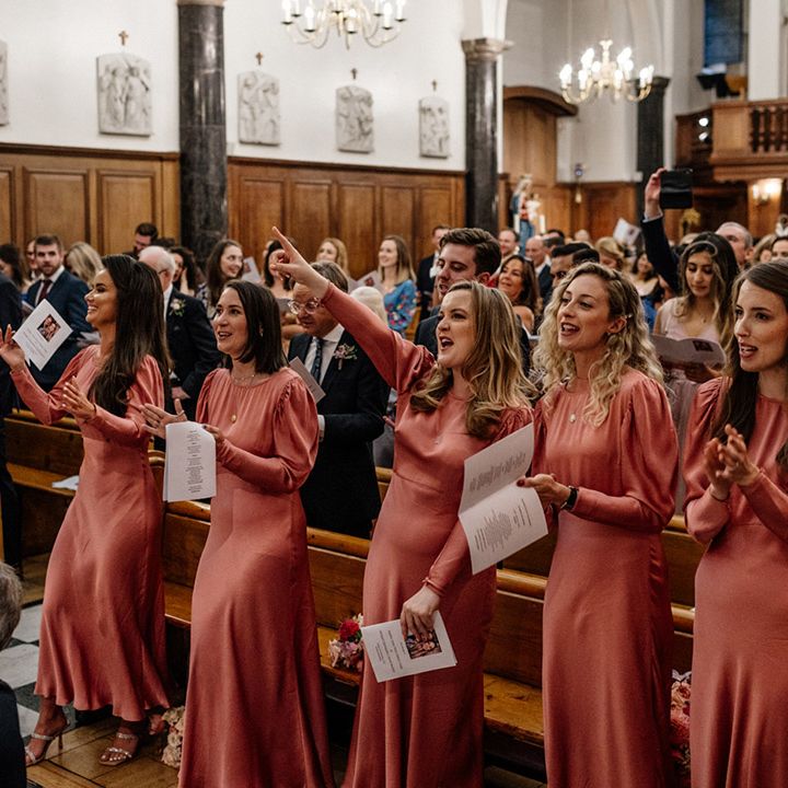 Bridal party in Ghost pink satin bridesmaid dresses with long sleeves