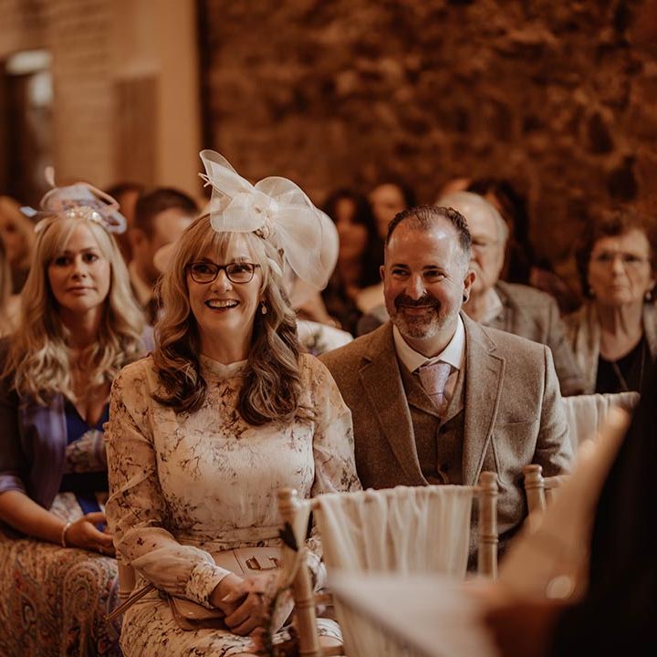 Wedding guests watch the wedding ceremony excitedly 