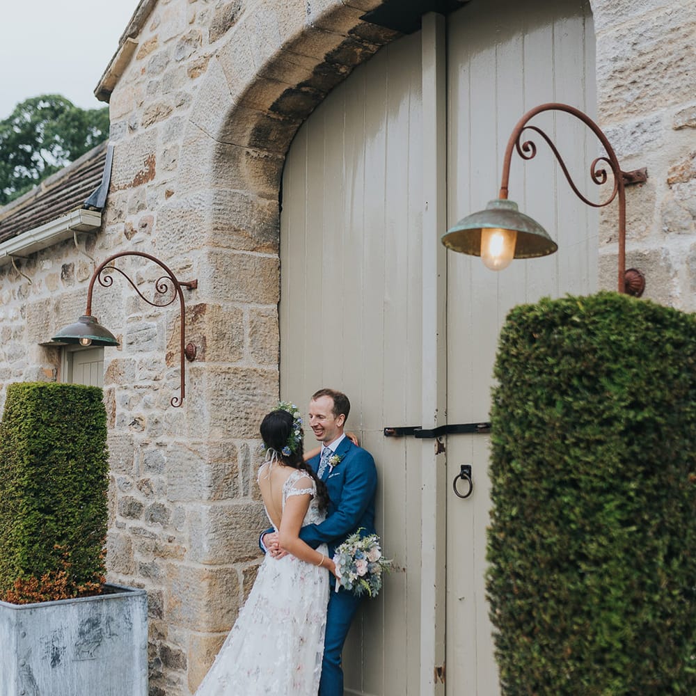 The Tithe Barn Bolton Abbey wedding with bride in a floral Savin London Amelia dress