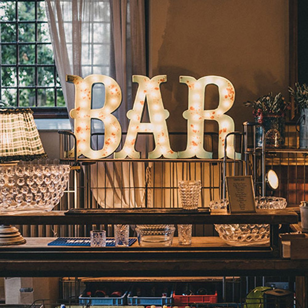 Destination wedding with rustic wedding bar including letter lights 