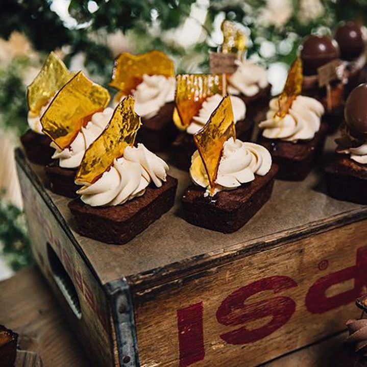 Chocolate brownies decorated with frosting including sugar glass and chocolate 