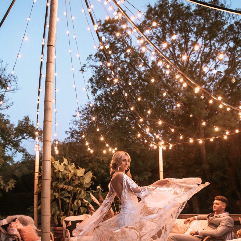 Bride showing off Rue de Seine lace wedding dress overlay details