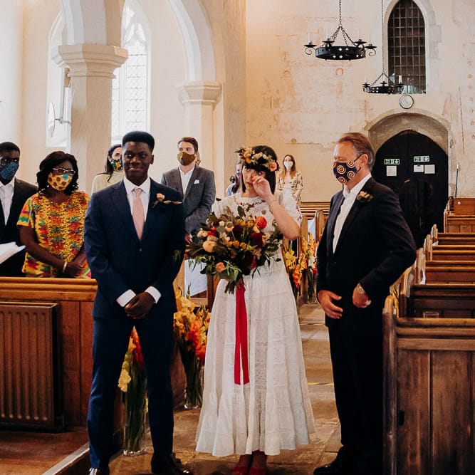 Church wedding ceremony bridal entrance with emotional bride at the altar with her father and groom 