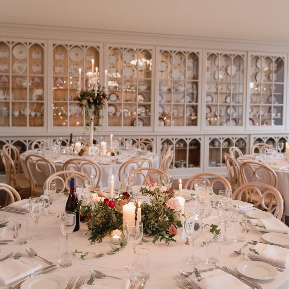 White table décor with accents of red and berry at Brympton House 