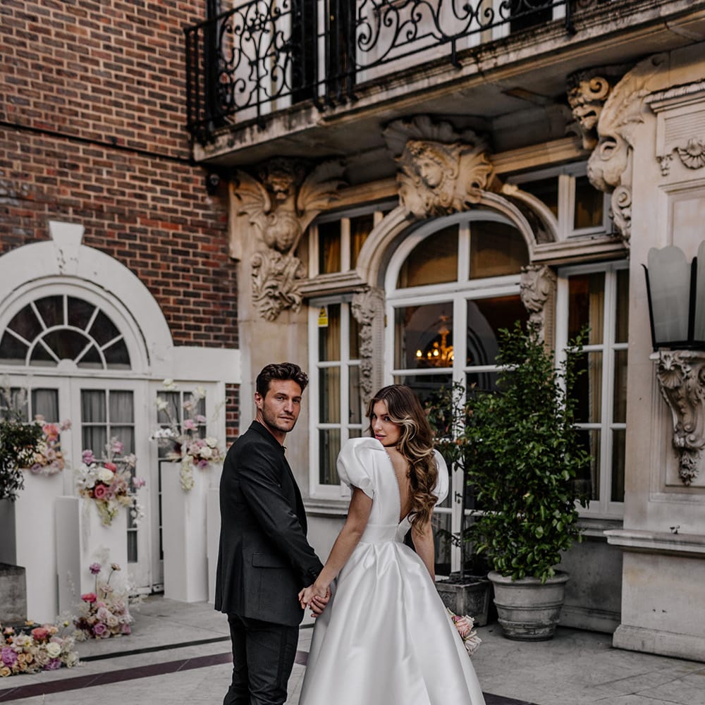 Luxury wedding with bride in a princess wedding dress with puff sleeves, low back and long train