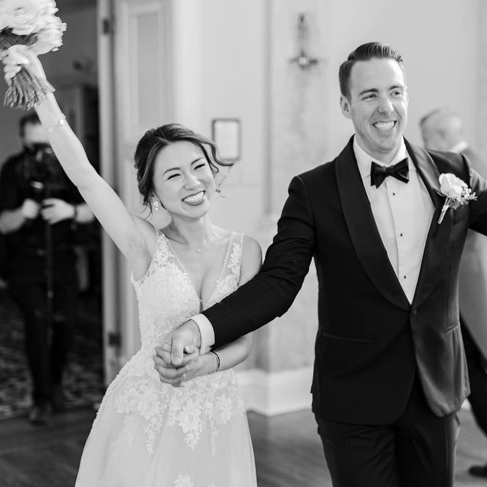Bride & groom celebrate in black & white image after wedding ceremony