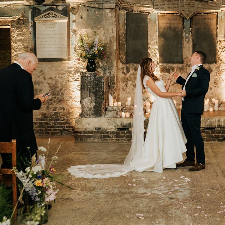 Bride in two piece high low wedding skirt and cathdral length veil with lace detail at Asylum Chapel wedding venue