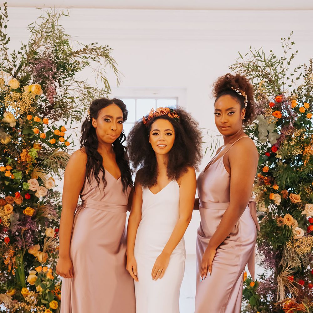 Bridal party with bride in a white satin slip wedding dress and bridesmaids in rose satin bridesmaid dresses 