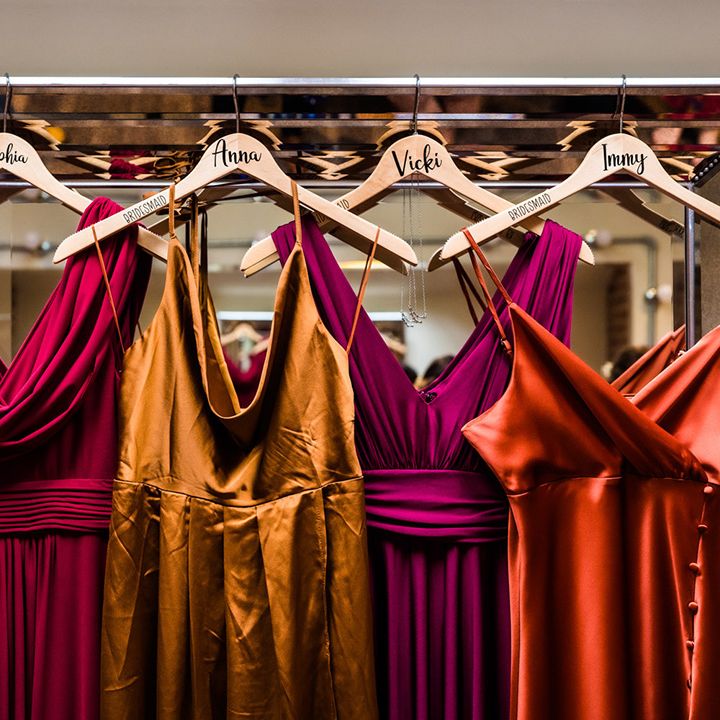 Red, purple, yellow and orange bridesmaids dresses in autumnal jewel colours for lesbian wedding at Foxtail Barns venue