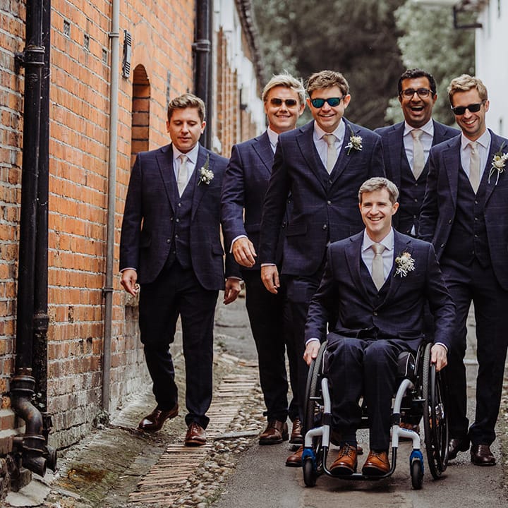 Groom with the groomsmen in blue suits and gold ties for the Henley Brewery wedding 
