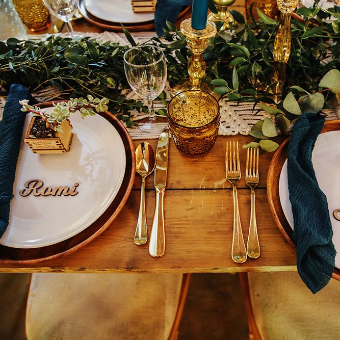 Rustic tablescape with macrame table runner, plant favours in personalised wooden box and pops of gold throughout