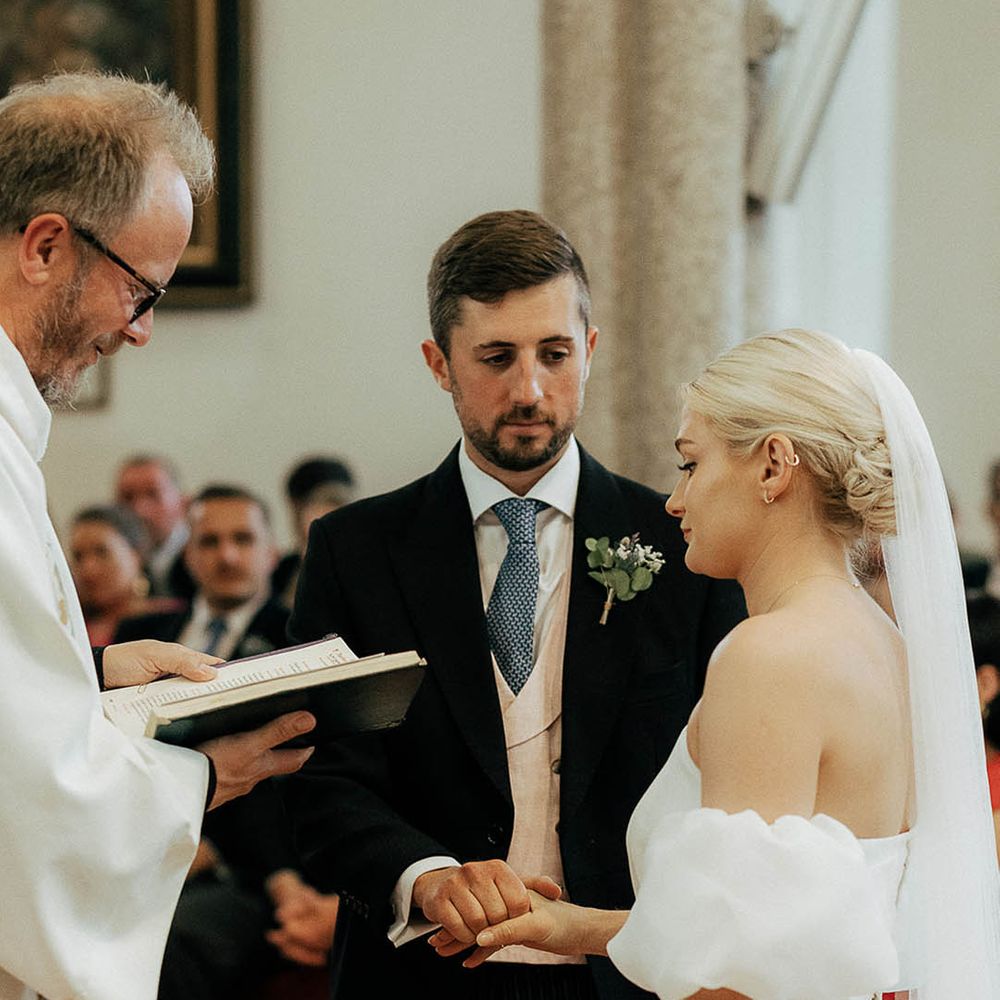 Bride & groom during wedding vows in church ceremony 
