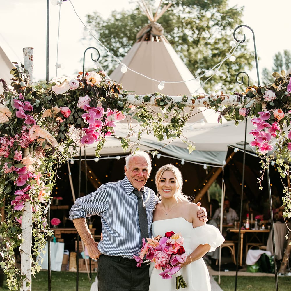 Bride and grandad pose together for special tipi wedding 