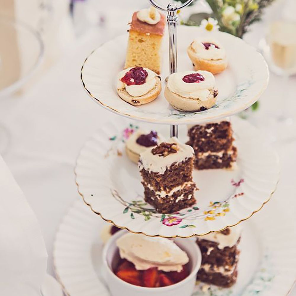 Afternoon tea stand with cakes and sweet treats by Claire Penn Photography