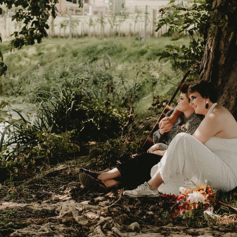 Bride in jumpsuit and trainers at 70s inspired wedding 