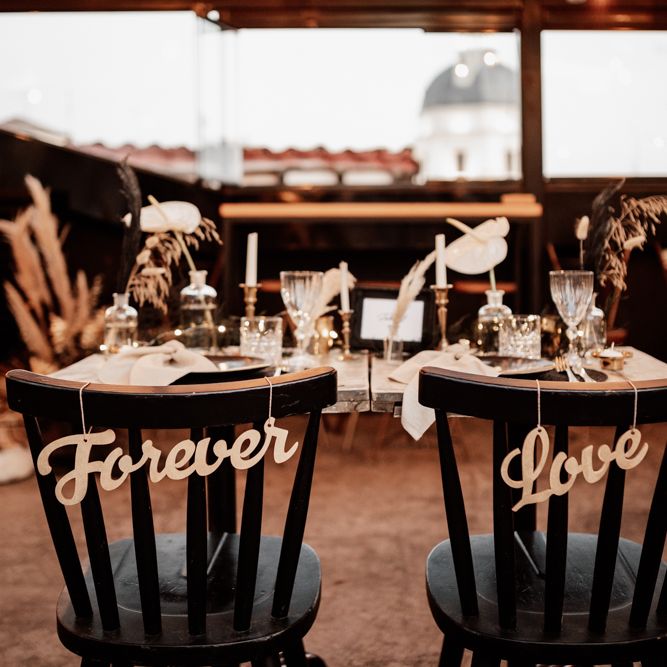 Black chairs with 'Forever Love' signs