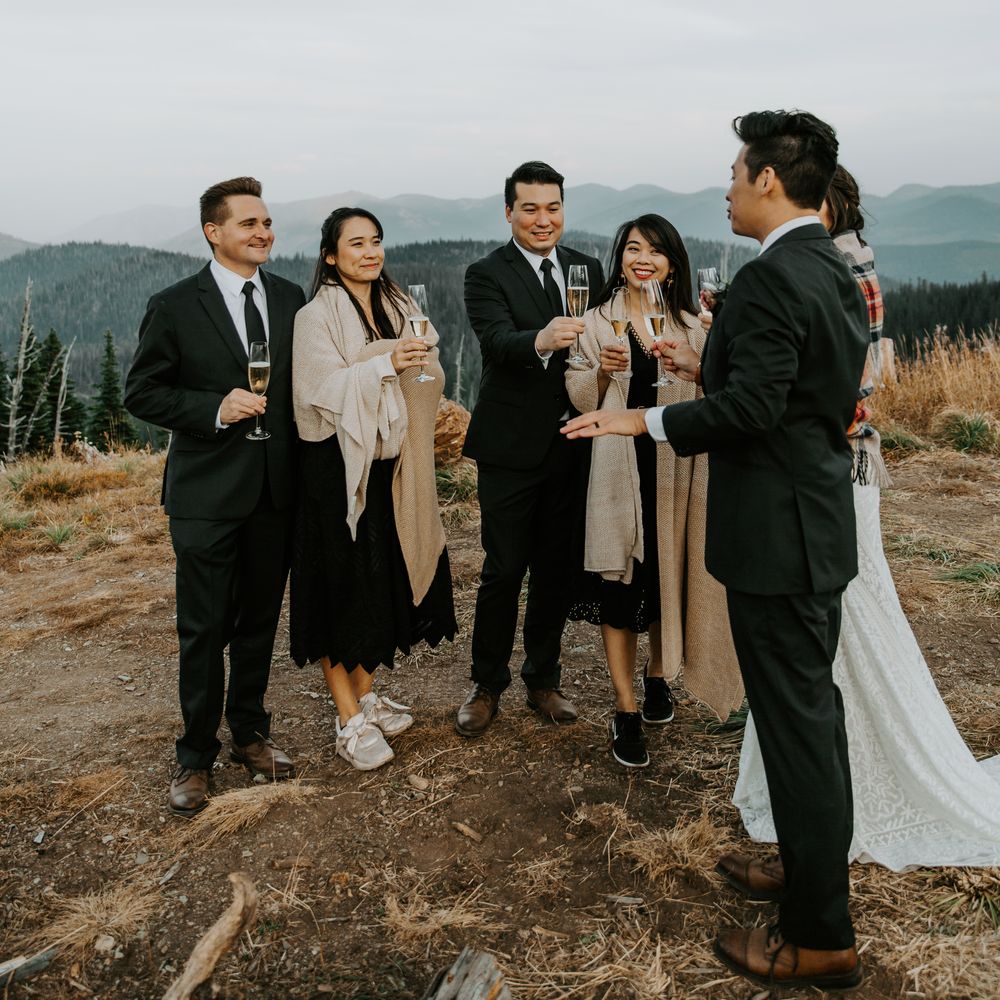 Bride & groom stand with wedding party after wedding ceremony 