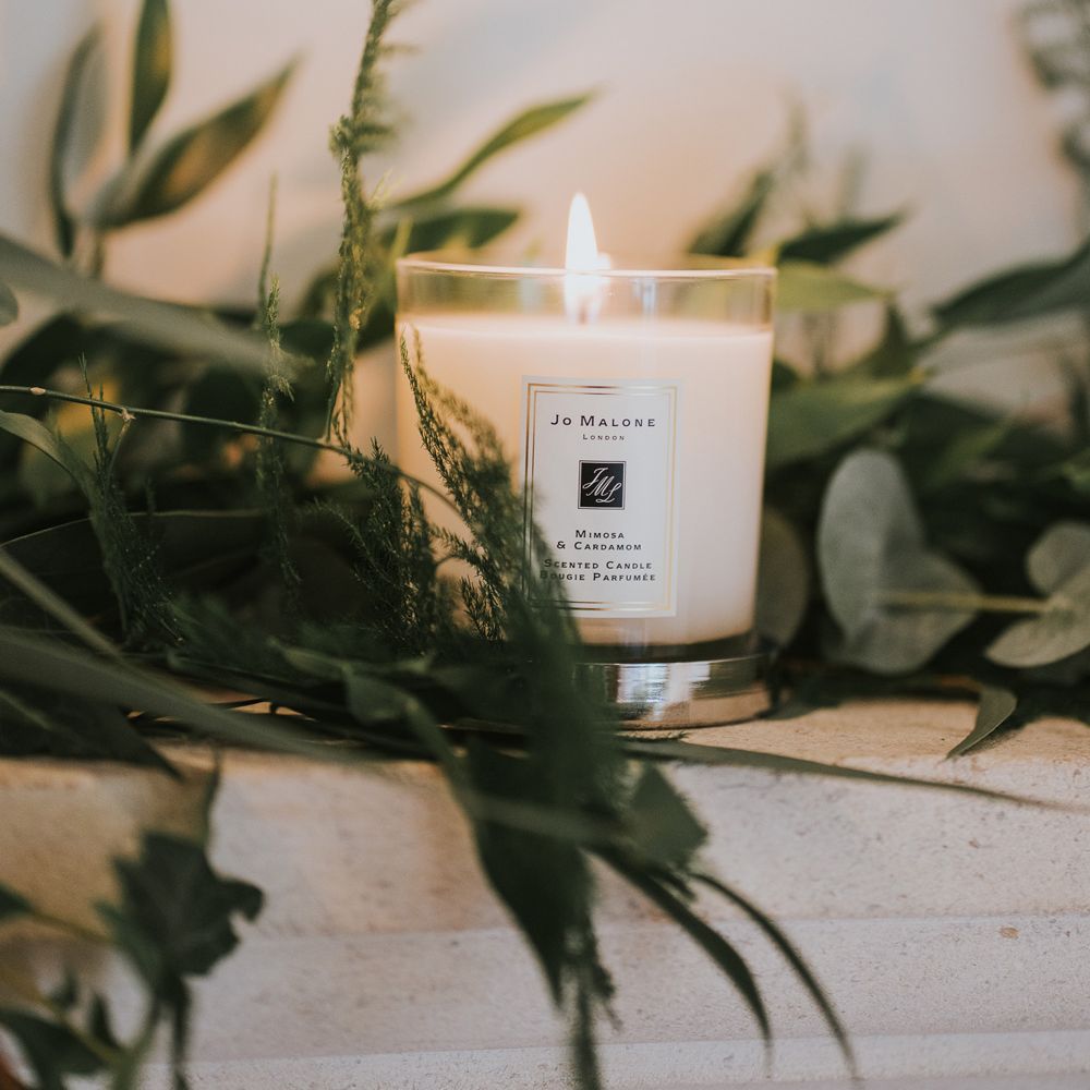 Jo Malone candle surrounded by greenery at Notley Abbey wedding