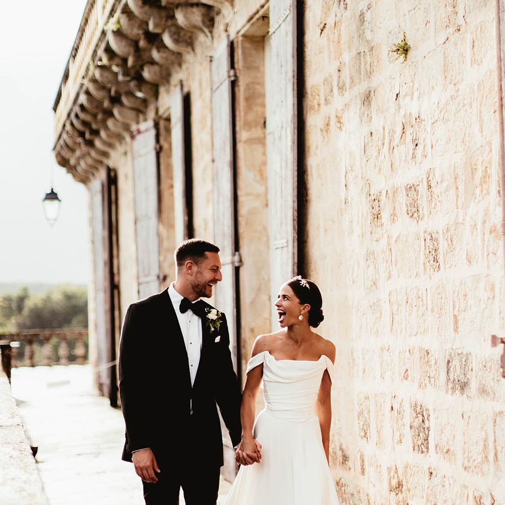 Bride & groom walk hand in hand on their wedding day