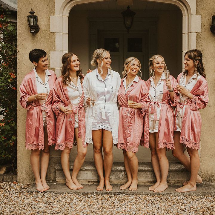 Bridesmaids in pink getting ready robes