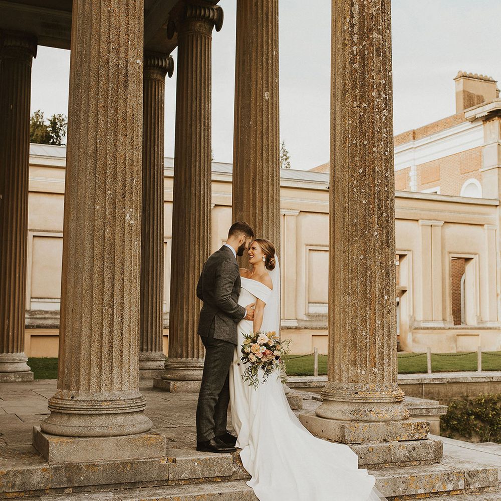 Groom places his hands on his brides waist as they look lovingly at one another