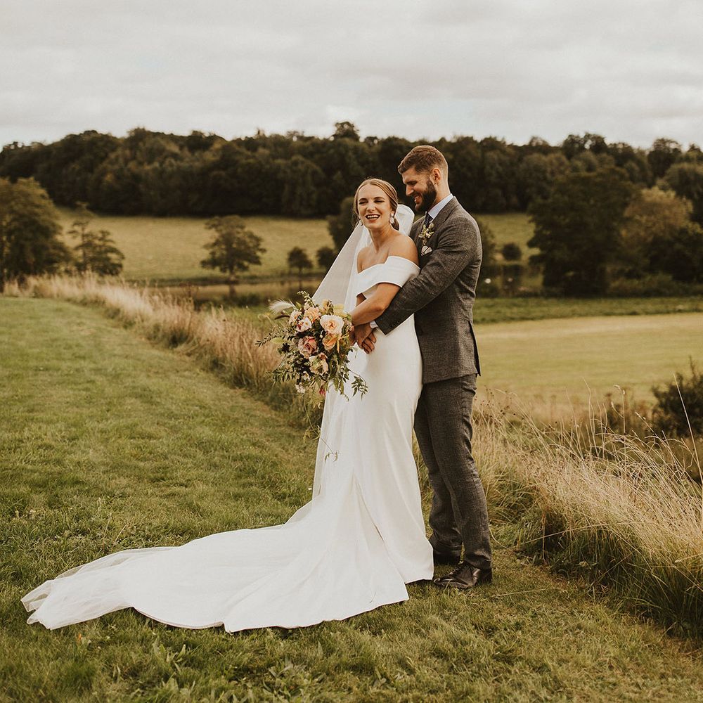 Groom wraps his arms around bride on their wedding day