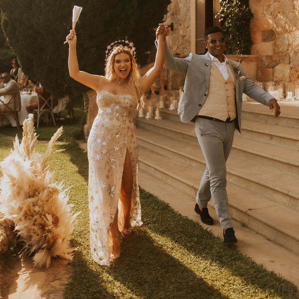 Bride & groom walk hand in hand with one another