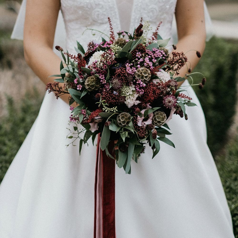 Winter burgundy bouquet tied with velvet ribbon